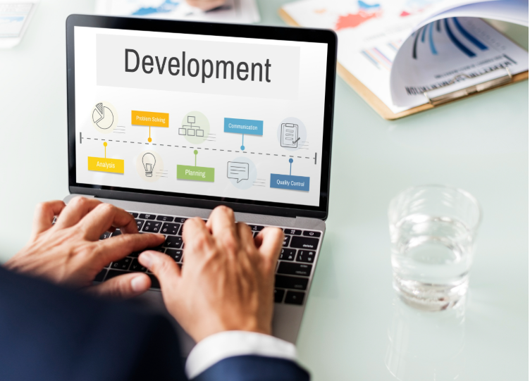 Professional working on a laptop displaying a software development workflow for business growth and digital project planning in 2026